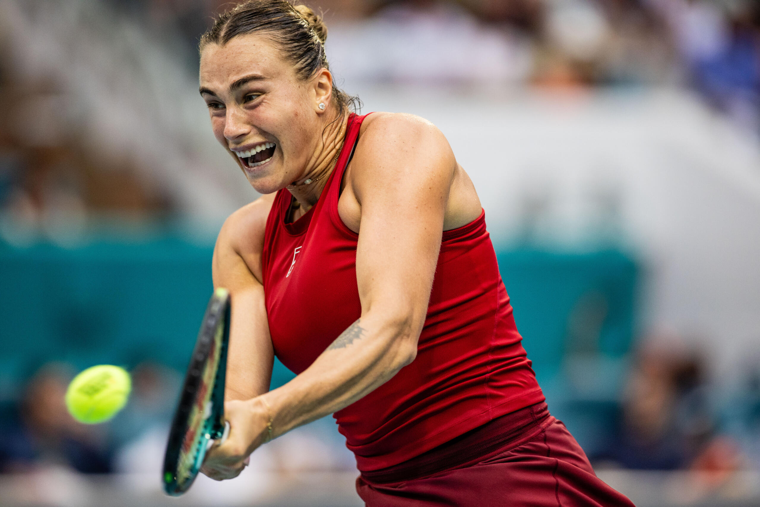 A player powering through a backhand with an intense expression