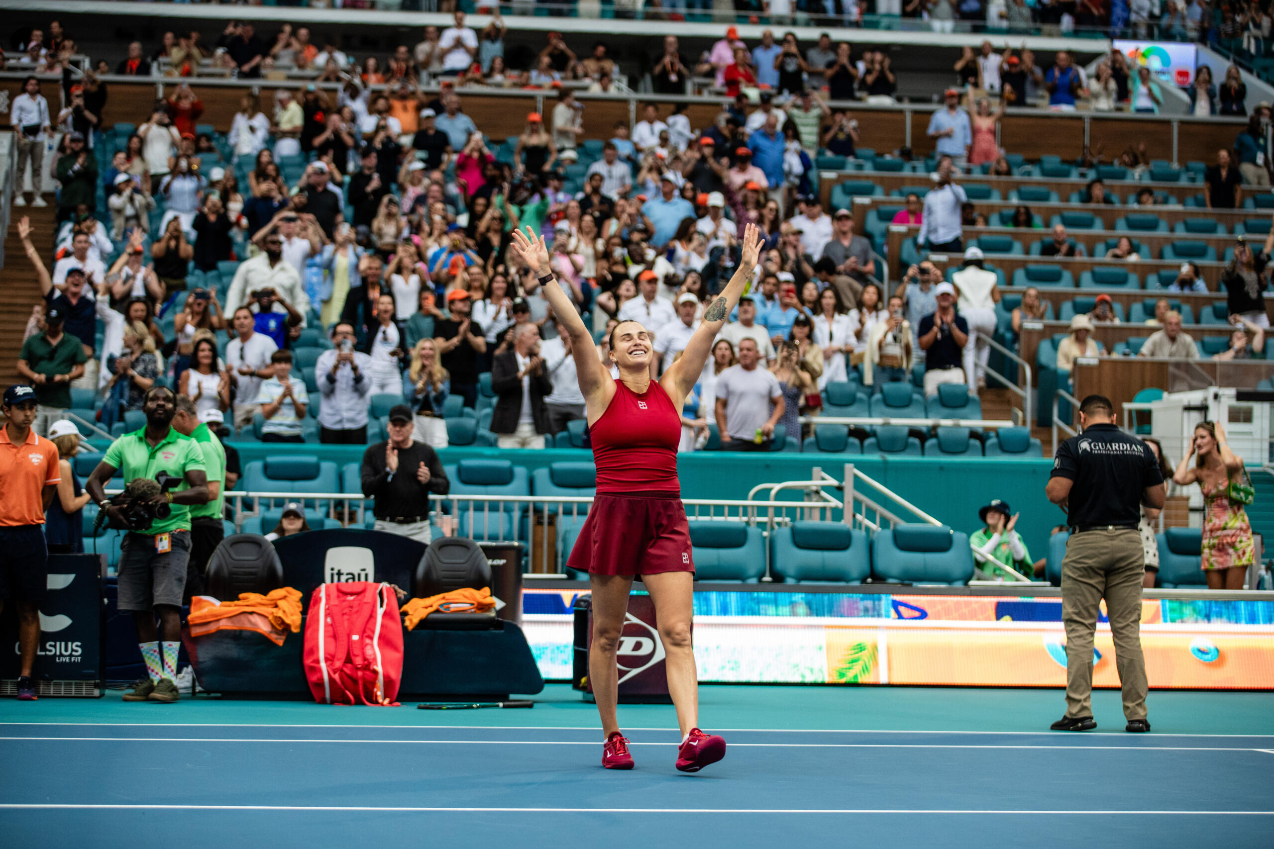 The women's champion raising her arms to the crowd after match point
